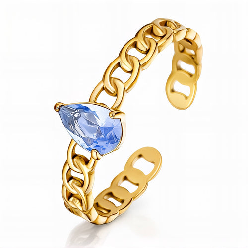 Aria Ring — gold curb chain band with blue pear-cut cubic zirconia